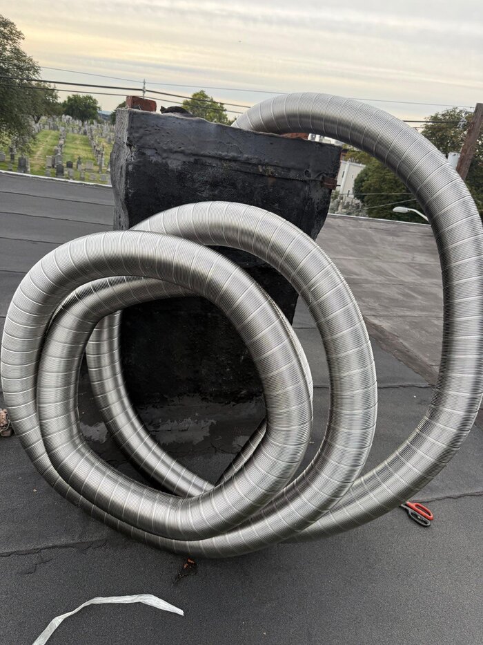 Stainless steel chimney liner ready for installation on rooftop